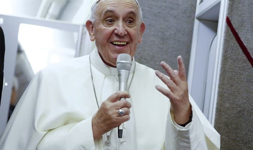 Papa Francisco fala dentro de avião durante sua viagem de volta para Roma. (Foto: Tony Gentile/Reuters)