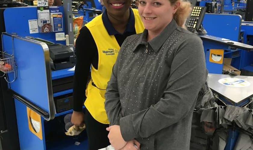 A funcionária Sharnique Dasant ao lado da cliente Ashley Jordan, em frente ao caixa do Walmart. (Foto: Reprodução/Facebook)