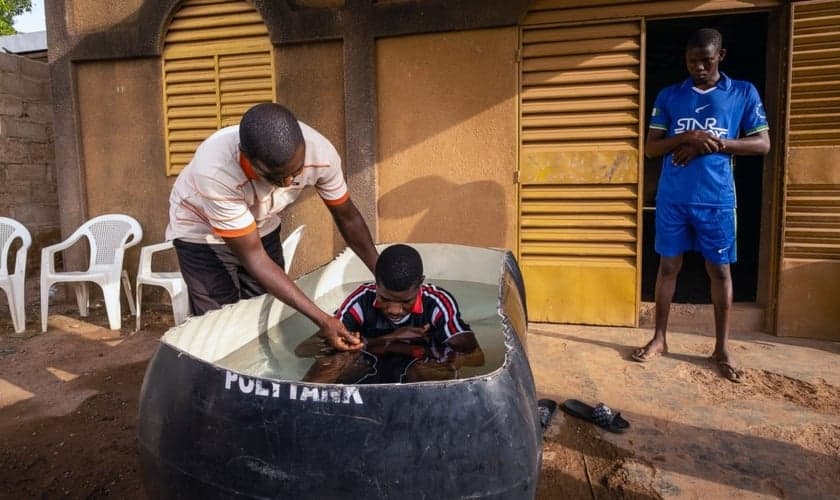 Pastor de Burkinabé, Bonogo Fulgence, batiza dois caminhoneiros em Ouagadougou, Burkina. (Foto: Reprodução / IMB)