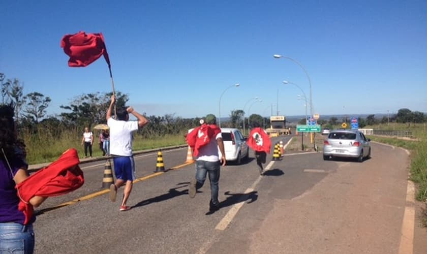 Militantes petistas correm atrás de um dos carros que acompanhou a volta de José Genoino para o presídio da Papuda 