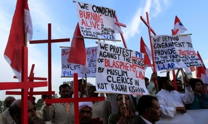Membros da comunidade cristã paquistanesa seguram cartazes durante protesto contra a perseguição religiosa, após a morte de um casal cristão na província de Punjab, em 2014. (Foto: Reuters)
