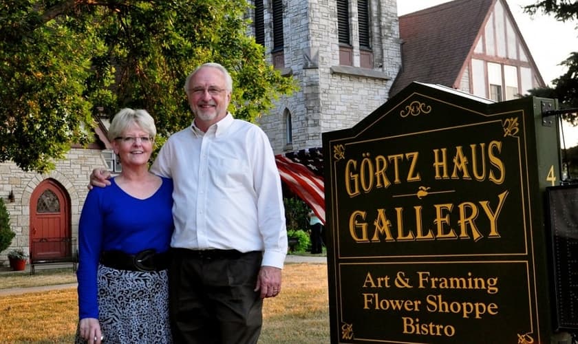O casal Richard e Betty Odgaard em frente ao Görtz Haus Gallery — um bistrô com espaços para exposições de arte. (Foto: The Becket Fund)