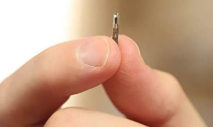 Do tamanho de um grão de arroz, chip é implantado na mão, entre os dedos indicador e polegar. (Foto: BBC)
