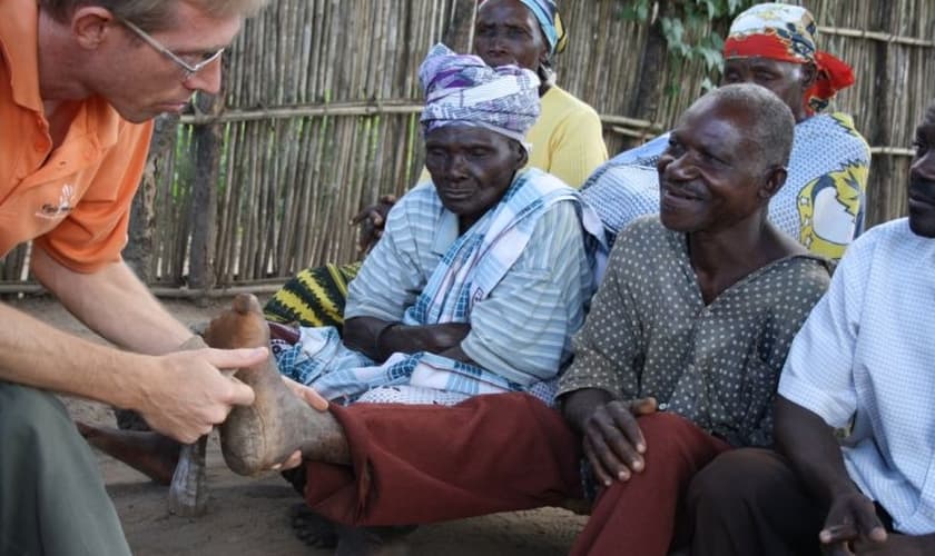 Doutor Arie De Kruijff examinando os pés de um homem com lepra. (Foto: Leprosy Mission)