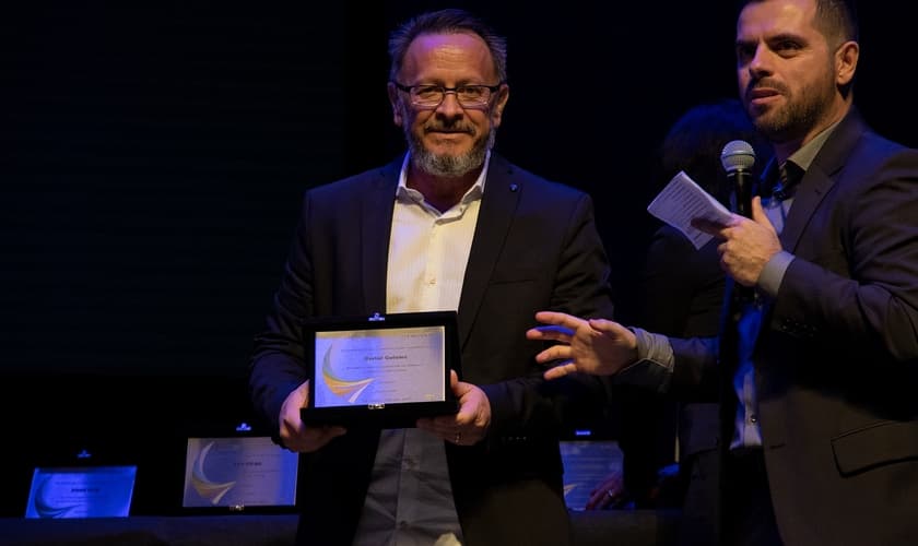 Marcos Corrêa, diretor do Guiame, segura placa em homenagem à atuação do portal. (Foto: Guiame/Marcos Paulo Corrêa)
