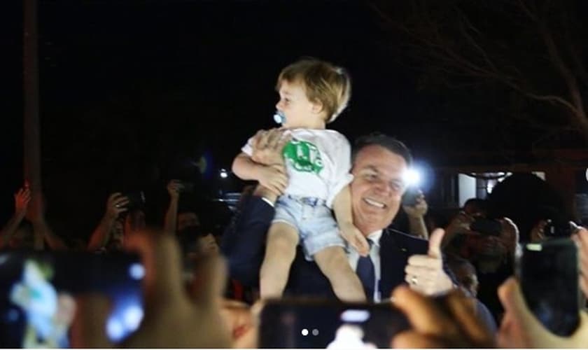 Bolsonaro segura nos braços o pequeno Noach, neto do pastor Joel Engel. (Foto: Arquivo pessoal)