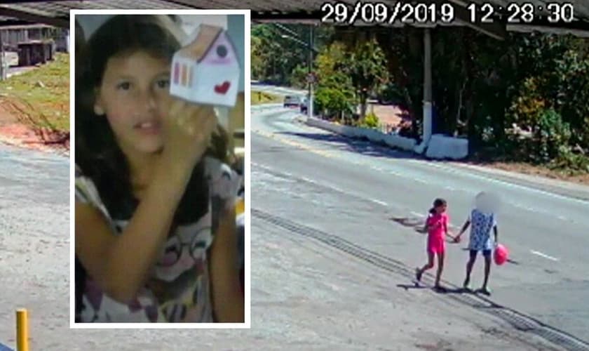 A menina Raíssa de mãos dadas com adolescente, em Perus. (Foto: Reprodução/TV Globo)