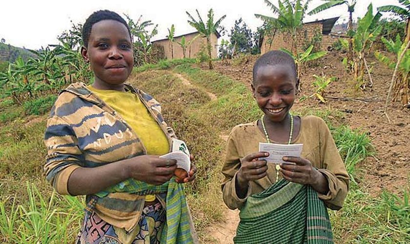 Meninas africanas recebem folhetos evangelísticos em seu idioma. (Foto: Reprodução/CHVN)