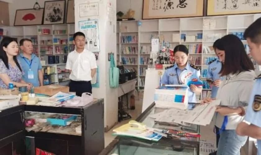 Oficiais revistando livraria na China. (Foto: Reprodução/Bitter Winter)