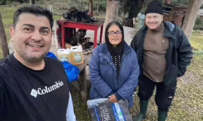 Pastores Tiago e Joel Engel com moradora do RS. (Foto: Reprodução/Ministério Engel)