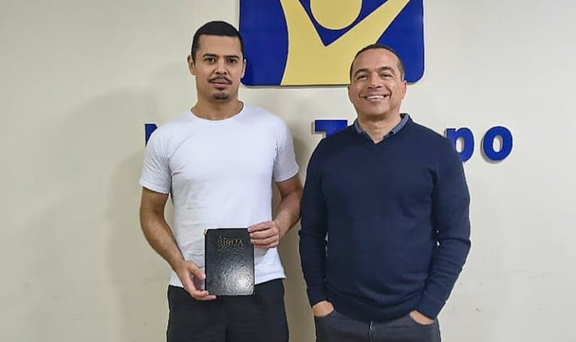 Jadesson e Willyan com a Bíblia perdida. (Foto: Reprodução/Notícias Adventistas)